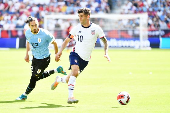 Christian Pulisic dribbles the ball for the United States Men's National Team.