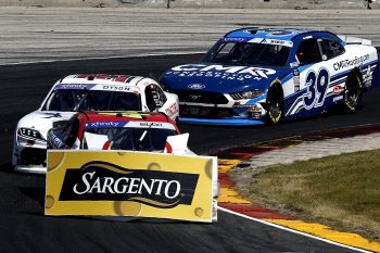 Josh Bilicki, driver of the No. 44 Chevrolet, drives with signage debris after an on-track incident during the NASCAR Xfinity Series Henry 180 at Road America on July 2, 2022 in Elkhart Lake, Wisconsin.