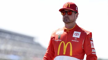 Kurt Busch walks the grid during qualifying for the NASCAR Cup Series M&M's Fan Appreciation 400 at Pocono Raceway on July 23, 2022.