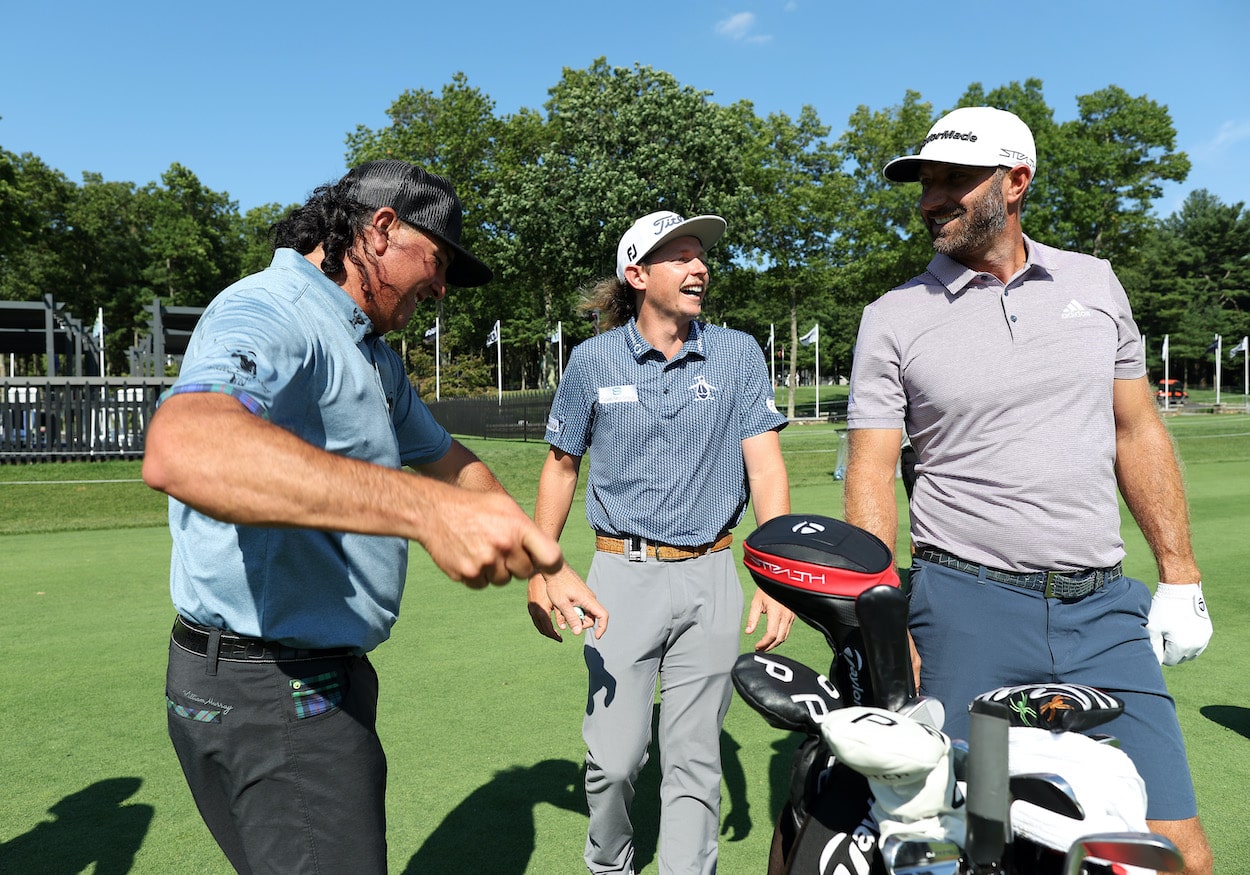 Pat Perez, Cameron Smith, and Dustin Johnson laugh on the range.