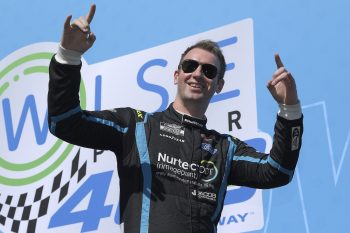 Cody Ware waves to fans as he walks onstage during driver intros for the NASCAR Cup Series Wise Power 400 at Auto Club Speedway on Feb. 27, 2022 in Fontana, California.