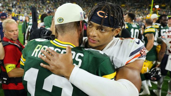 Justin Fields of the Chicago Bears hugs Aaron Rodgers of the Green Bay Packers.