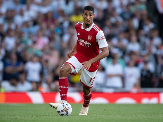 William Saliba dribbles the ball during an Arsenal match.