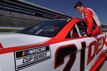 Harrison Burton climbs into his Cup Series car during a practice session.