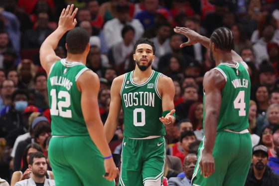 Jayson Tatum of the Boston Celtics celebrates with Grant Williams and Noah Vonleh against the Chicago Bulls.