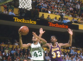 Gerald Henderson of the Boston Celtics goes in for a layup in front of Magic Johnson of the Los Angeles Lakers.