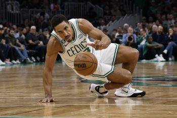 Malcolm Brogdon of the Boston Celtics slips while dribbling the ball.