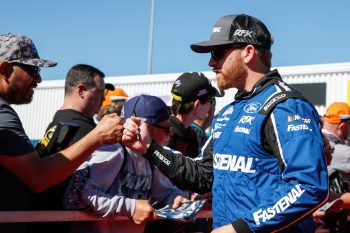 Driver Chris Buescher fist bumps fans before the 2022 NASCAR Cup Series Championship Race