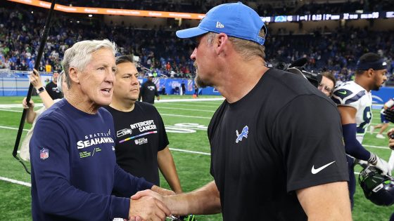 Head coach Pete Carroll of the Seattle Seahawks shakes hands with head coach Dan Campbell of the Detroit Lions. The Seahawks and Lions have the Rams and Broncos first-round picks in the 2023 NFL Draft.
