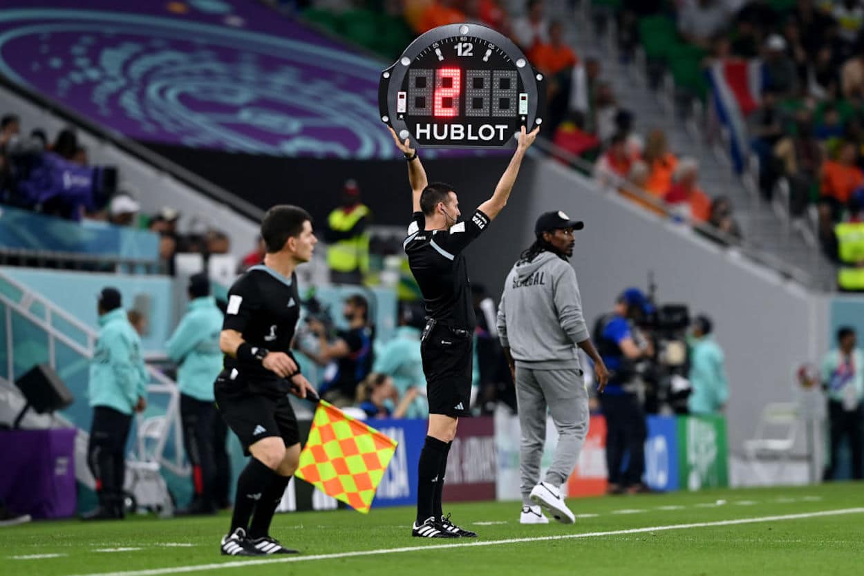 A fourth official holds up the board showing there will be two minutes of stoppage time.