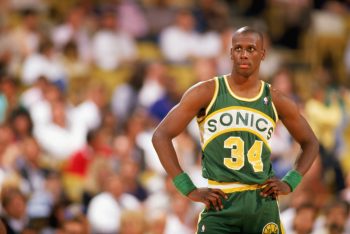 Xavier McDaniel of the Seattle Supersonics looks on.