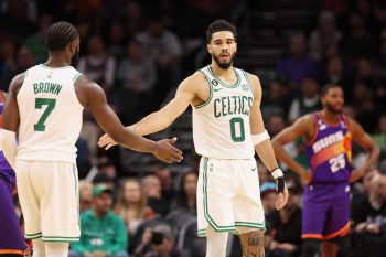 Jayson Tatum of the Boston Celtics high-fives Jaylen Brown.