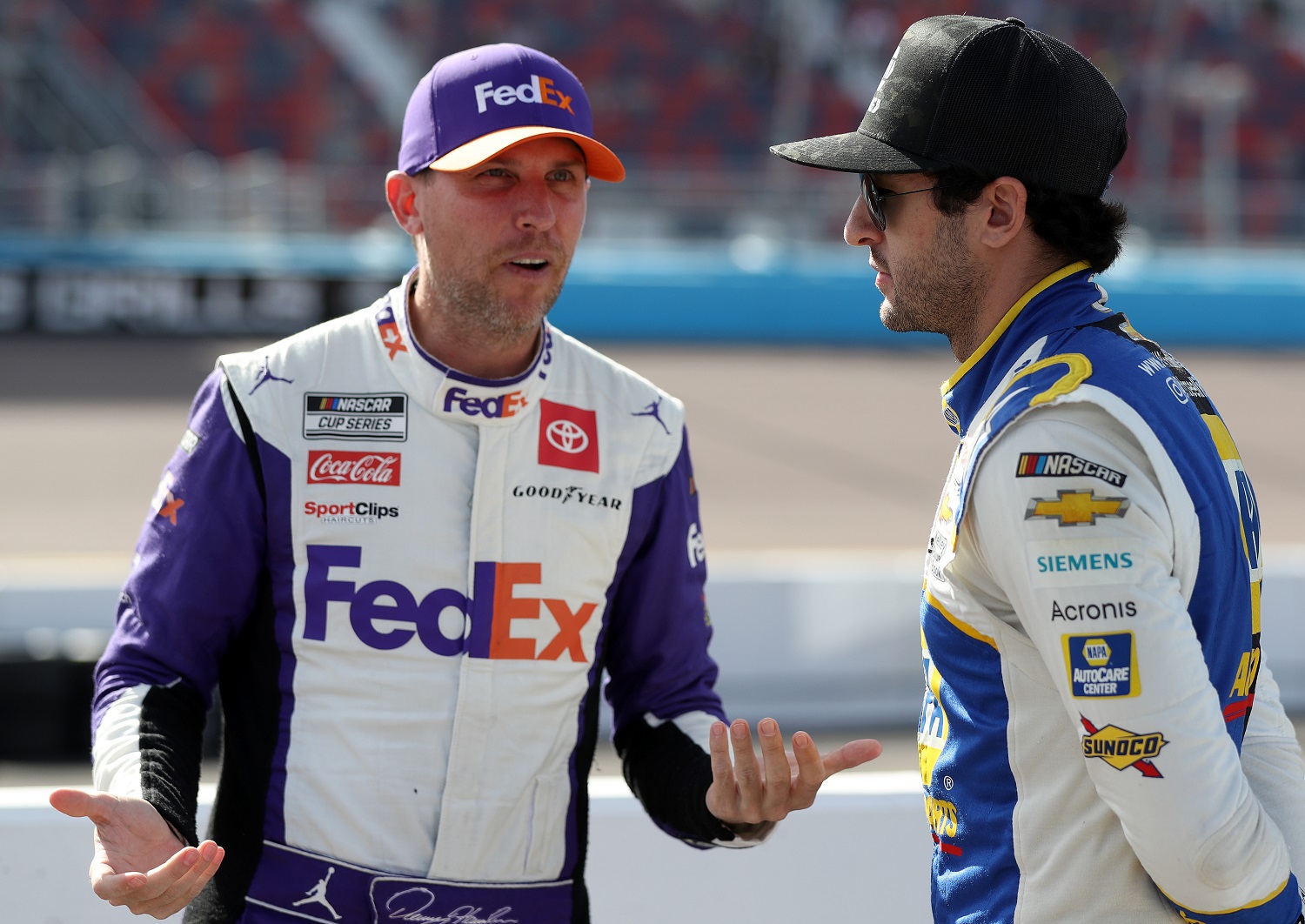 Denny Hamlin, left, talks with Chase Elliott during qualifying for the NASCAR Cup Series Championship at Phoenix Raceway on Nov. 5, 2022.