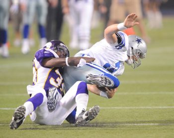 Husain Abdullah of the Minnesota Vikings sacks Jon Kitna of the Dallas Cowboys during a 2009 game