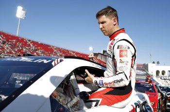 Denny Hamlin enters his car for a qualifying heat in the NASCAR Clash at the Coliseum at Los Angeles Memorial Coliseum on Feb. 5, 2023.