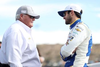 Rick Hendrick (L) and Chase Elliott (R) talk on the grid.