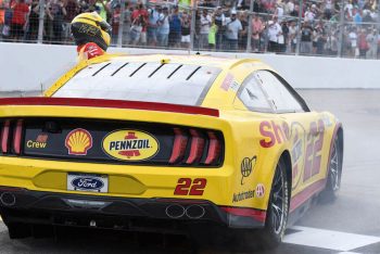 Joey Logano climbs into his Next Gen car.