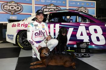 Alex Bowman poses for photos after winning the the Busch Light Pole Award at Daytona International Speedway on Feb. 15, 2023.