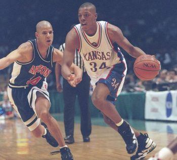 Forward Paul Pierce of the Kansas Jayhawks drives the ball past guard Miles Simon of the Arizona Wildcats.