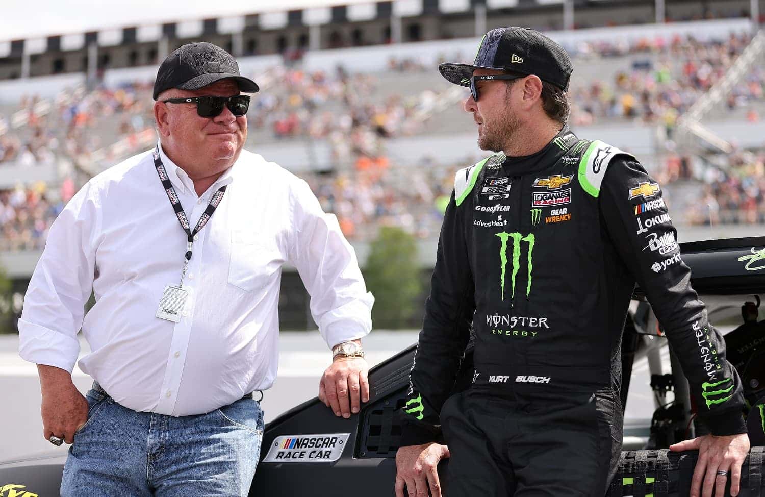Driver Kurt Busch and team owner Chip Ganassi talk on the grid prior to the NASCAR Cup Series Pocono Organics CBD 325 at Pocono Raceway on June 26, 2021. | James Gilbert/Getty Images
