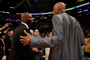 Kareem Abdul-Jabbar pats Kobe Bryant on the back at Bryant's Lakers jersey retirement ceremony in 2017