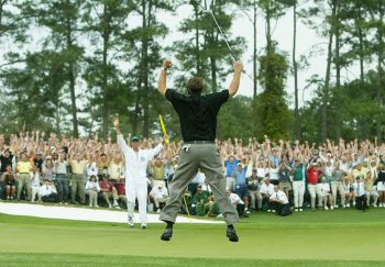 Golfer Phil Mickelson celebrates a putt with his caddie