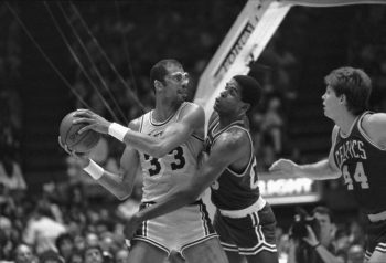 Boston Celtics center Robert Parish tries to swat the ball away from Kareem Abdul-Jabbar of the Los Angeles Lakers