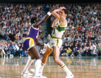 Michael Cooper of the Los Angeles Lakers puts the pressure on Phil Smith of the Seattle SuperSonics.