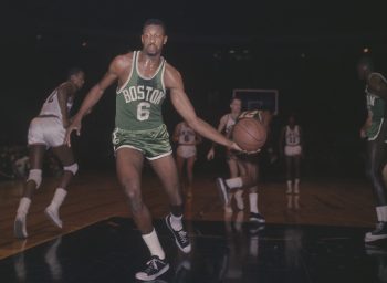 Bill Russell of the Boston Celtics takes the ball after a New York Knicks score circa the 1960s.