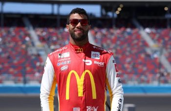 NASCAR driver Bubba Wallace stands on the track before a race