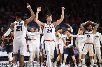 Rui Hachimura (from left) and Corey Kispert of the Gonzaga Bulldogs celebrate during the West Coast Conference basketball tournament on March 11, 2019