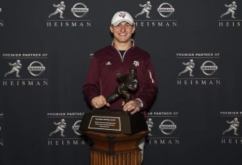 Johnny Manziel of Texas A&M poses with the Heisman Trophy in 2013