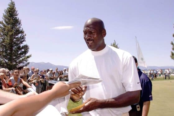 Michael Jordan signs an autograph for a fan