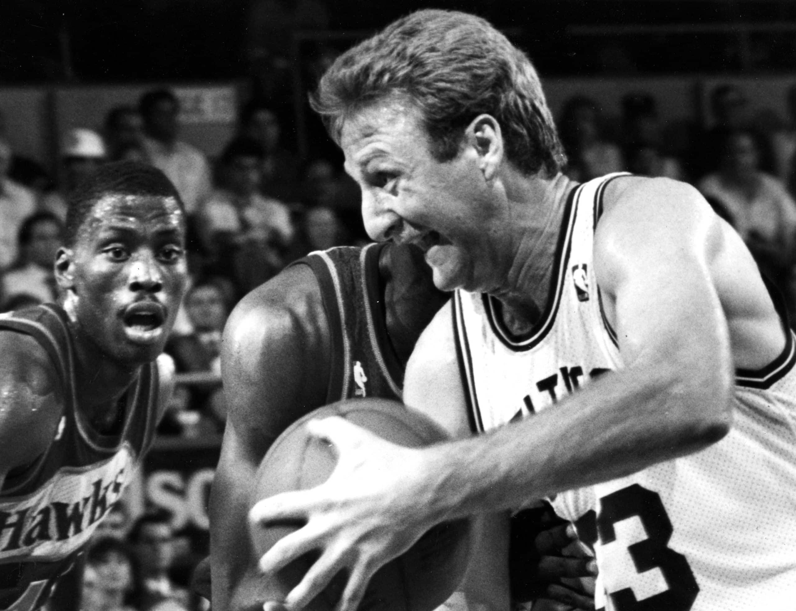 Larry Bird controls the ball against the Atlanta Hawks.