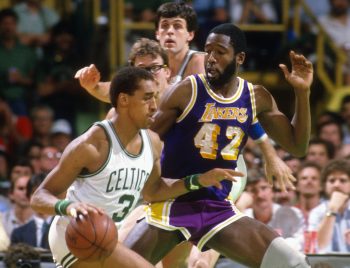 Dennis Johnson of the Boston Celtics drives on James Worthy of the Los Angeles Lakers.
