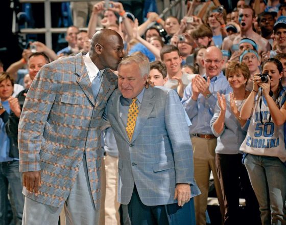 Tar Heels alumni Michael Jordan kisses former Tar Heels coach Dean Smith in 1993