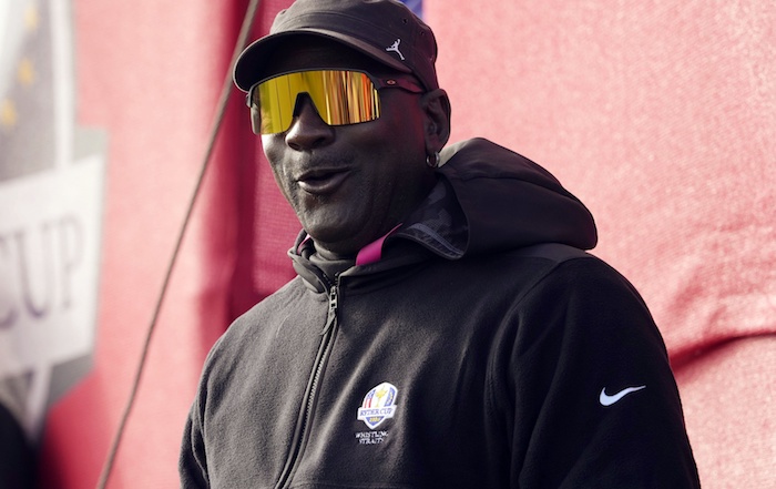 Michael Jordan watches on from the 11th green during day two four-ball .