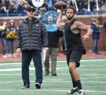 Jim Harbaugh watches former 49ers quarterback Colin Kaepernick.