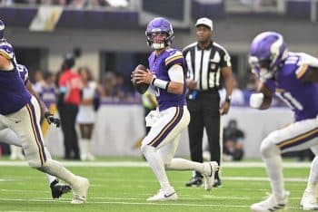 Minnesota Vikings quarterback J.J. McCarthy (9) looks to pass.