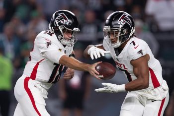 Atlanta Falcons quarterback Kirk Cousins (18) hands off to running back Bijan Robinson (7).