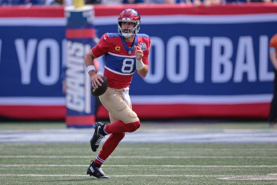 Giants quarterback Daniel Jones (8) rolls out during the first half.