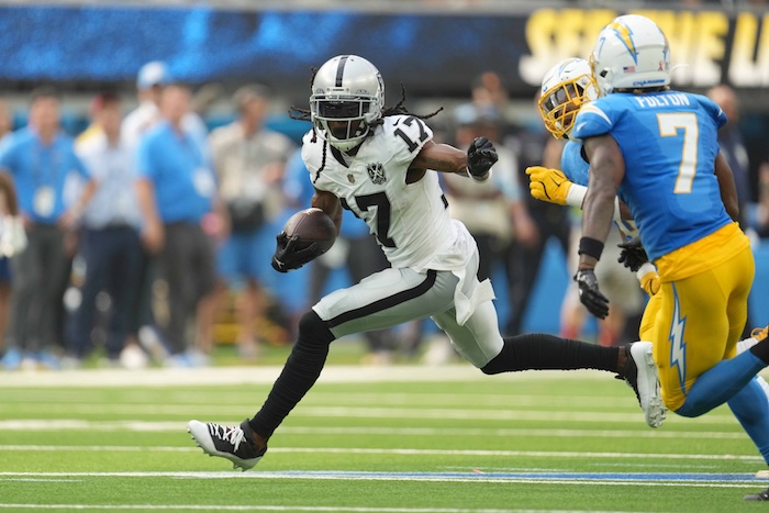 Las Vegas Raiders wide receiver Davante Adams (17) carries the ball against Los Angeles Chargers cornerback Kristian Fulton.